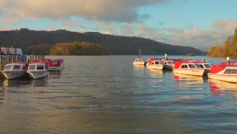 Boats-docked-on-Lake-Windermere-in-the-late-afternoon-at-golden-hour---From-Bowness-on-Windermere,-England