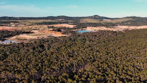 Drone-tracking-towards-quarry-in-Victoria,-Australia