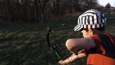 Close-Up-Slow-Motion-Of-A-Boy-With-A-Bow-And-Arrow-Outdoor