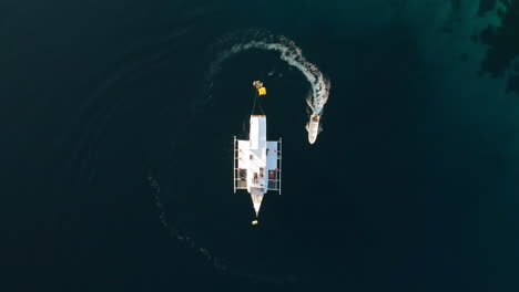 Aerial-view-of-speedboat-Turn-Around-The-Ship-at-The-Ocean