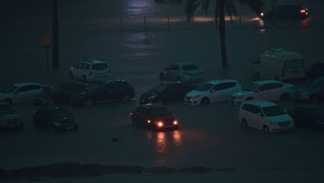 On-April-16,-2024,-cars-were-stuck-in-the-flood-during-nighttime-rain-in-Sharjah,-UAE