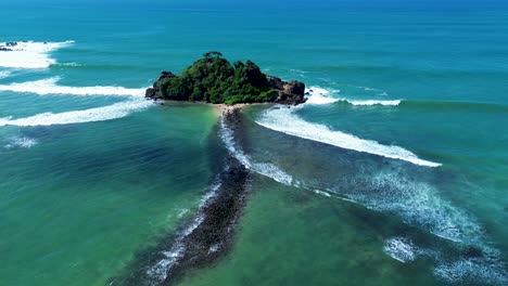 Aerial-drone-landscape-view-of-Devil's-rock-island-sandy-beach-Indian-ocean-reef-channel-inlet-water-nature-forest-Midigama-Sri-Lanka-Asia-travel-tourism