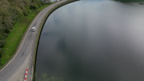aerial-view-of-white-van-with-tourists-explores-the-Sete-Cidades-lake-in-the-Azores