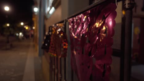 Close-up-view-of-traditional-mexican-plastic-paper-decorations-on-street-at-night