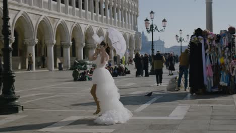 Bride-with-parasol-walking-by-Venetian-stalls