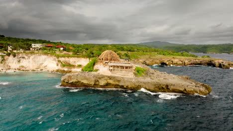 New-building-under-construction-on-rocky-cliff-of-Blue-Lagoon-Nusa-Ceningan,-Lembongan,-Bali-in-Indonesia