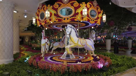 Approach-shot-of-a-miniature-indoor-carousel