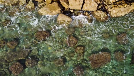 Rocky-Mediterranean-Shoreline-in-Calpe,-Spain:-Aerial-Drone-View,-Birds-Eye-looking-down