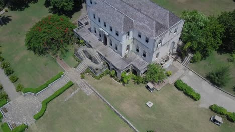 A-drone-shot-of-Rose-Hall-in-Jamaica,-a-Georgian-plantation-house-now-run-as-a-historic-house-museum,-located-in-Montego-Bay