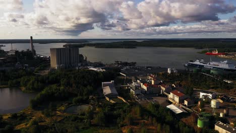 Aerial-view-cirling-the-Naantali-harbor,-summer-day-with-clouds-in-Proper-Finland