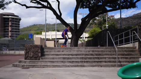 Traveler-does-a-skateboard-trick-down-a-set-of-stairs-in-Honolulu