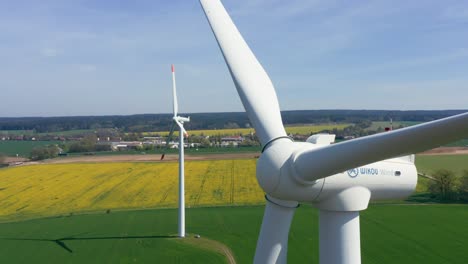 Clean-Energy-Winds-Turbine,-Camera-Aerial-View,-Camera-Lifts-Up