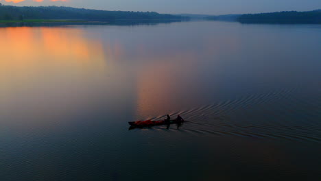 Morning-calm-lake-a-boat-is-flowing-the-surfaces-,-cloudy-morning-and-lake-reflecting-the-atmospheric-effects-of-the-sky