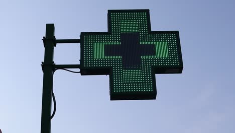 Illuminated-pharmacy-green-cross-sign-exterior
