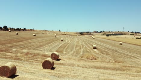 Round-Straw-Bales-in-Dry-Harvest-Cyprus-Farmland-Fields,-Aerial-Dolly-Shoot