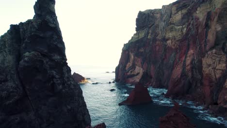 Aerial-of-High-Rocky-Cliffs-Above-the-Ocean,-Sunny-Day