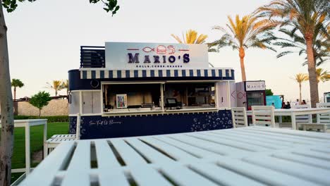 Front-view-of-stylish-and-light-dining-tables-in-an-outdoor-restaurant-wide-shot