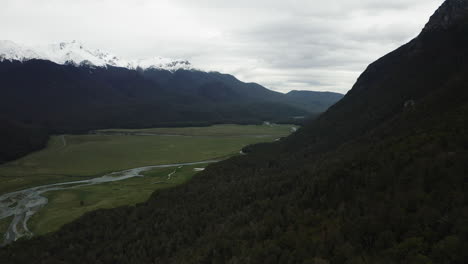 Eglinton-Valley-between-towering-snow-capped-mountains-is-renowned-for-is-stunning-Fjords-and-lush-evergreen-forests