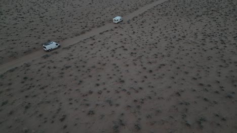 Camper-Trucks-Driving-In-Deserted-Landscape-In-Salt-Lake-City,-Utah,-USA---Aerial-Shot