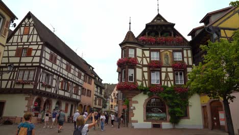 Woman-Takes-Picture-of-Half-Timbered-House-in-Kayserberg-Village