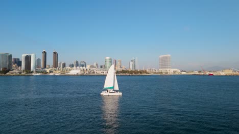 View-Of-Cityscape-And-Sailboat-On-The-San-Diego-Bay-In-California---Aerial-Drone-Shot