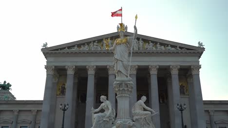 Austrian-Flag-Waves-in-a-Wind-on-Top-of-Austrian-Parliament-During-Warm-Summer-Evening