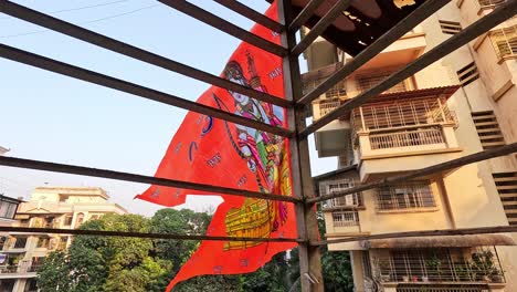 Ram-Mandir-flag-flutters-with-pride-in-house-balcony,symbolizing-unity-and-faith