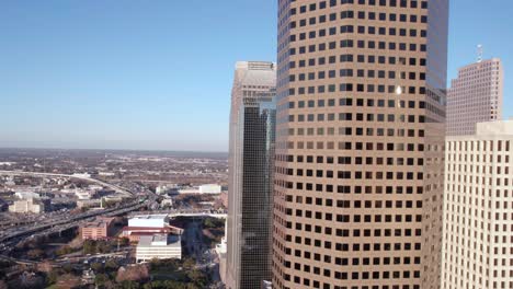 Aerial-View-of-Houston-TX-USA-City-Center-Buildings,-Highway-Traffic-and-Downtown-Skyscrapers,-Drone-Shot