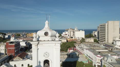Drone-flies-past-the-peak-of-the-Santa-Marta-Cathedral-and-across-the-city-of-Santa-Marta-in-Colombia