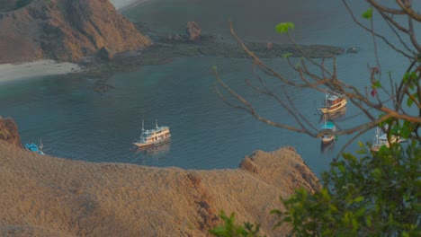 Boats-moored-in-bay,-Padar-island-in-Indonesia