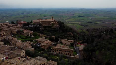 Aerial-view-of-old-town,-beautiful-medieval-village-of-Montalcino,-Italy,-orbiting