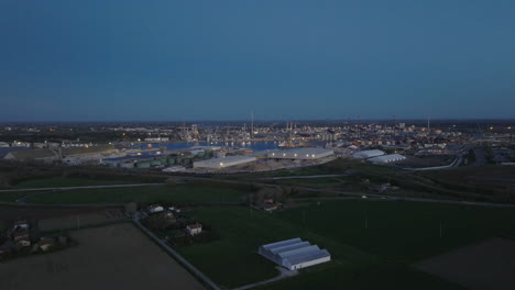Aerial-view-of-the-industrial-and-port-area-of-Ravenna-,chemical-and-petrochemical-pole,thermoelectric,metallurgical-plants-and-hydrocarbon-refinery-and-liquefied-natural-gas-tanks-at-night
