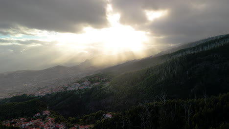 shoreline-of-Madeira,-Funchal-city-in-mountain-valley,-drone-establishment-shot,-Portugal