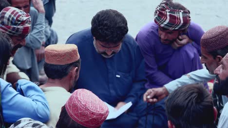 Shot-of-a-Pakistan-man-maintaining-record-of-the-food-distribution-in-Iftar-Drive-of-Balochistan,-Pakistan