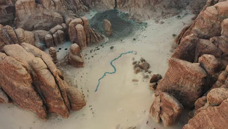 Aerial-view-of-the-"Glimpses-of-the-Past"-by-Zahra-Alghamdi,-at-Desert-X-AlUla,-Saudi-Arabia---circling,-drone-shot