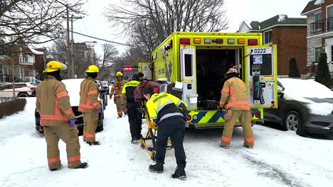 Paramedics-Unloading-Wheeled-Gurney-From-Back-of-Yellow-Ambulance