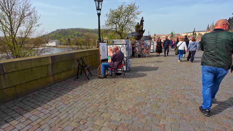 Artistas-Callejeros-Pintando-A-Lo-Largo-De-Un-Concurrido-Puente-De-Carlos-En-Un-Día-Soleado