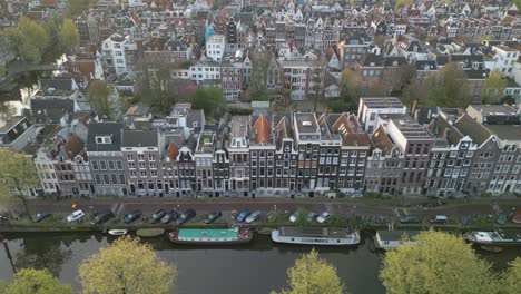 Birds-Eye-Aerial-View-Above-Famous-Canal-Streets-in-Amsterdam,-Dutch-Capital-City