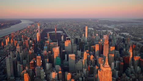 Aerial-view-of-the-Times-square,-the-Midtown-Manhattan-and-the-Central-park,-in-New-York-city,-colorful-sunset---Helicopter-shot