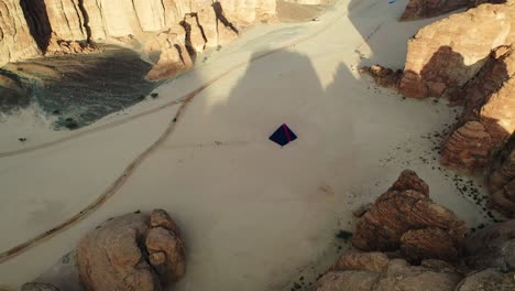 Aerial-view-overlooking-the-“A-Concise-Passage”-pyramid-by-Rashid-Alshashai-at-Desert-X-in-Al-Ula,-Saudi-arabia---circling,-drone-shot