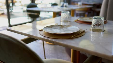 Front-view-of-stylish-and-light-dining-table-in-restaurant-close-up-shot,-pull-out-shot