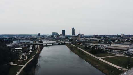 Drone-shot-over-the-Des-Moines-River-cutting-through-the-city's-downtown-sector