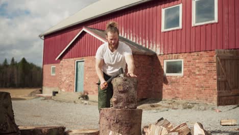 Portrait-Of-A-Caucasian-Guy-Chopping-A-Big-Timber-Log-During-Sunny-Day