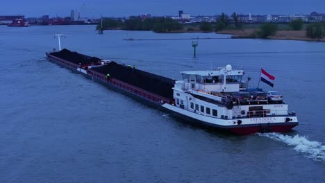 Bulk-Carrier-Loaded-With-Coal-On-River-At-Dusk-In-Zwijndrecht,-Netherlands