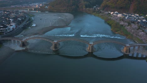 Sunrise-at-Kintaikyo,-Arched-Wooden-Bridge-in-Yamaguchi-Prefecture-Japan,-Aerial