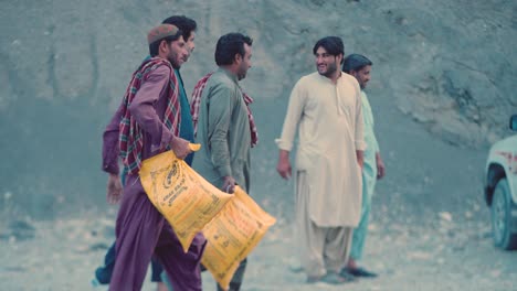 Locals-Carrying-Aid-Packages-To-Give-To-Poor-People-In-Balochistan-As-Part-Of-Food-Distribution-Aid