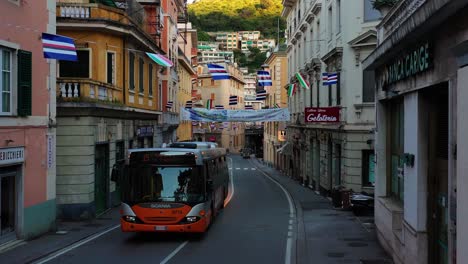 Aerial-view-of-a-bus-on-the-quiet-street-in-Genova-city,-sunny-evening-in-Italy