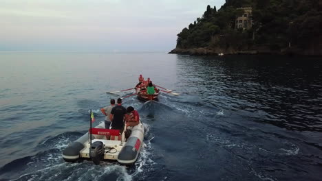 Drone-shot-following-a-rowing-team,-practicing-in-North-Italy,-summer-evening