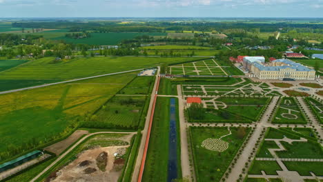 Rundale-Palace-Museum-With-Green-Park,-Moat,-And-Garden-In-Bauska,-Latvia