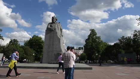 Tourists-take-a-photo-in-front-of-the-Monument-to-Karl-Marx-at-the-Center-of-the-Grand-Theater-Square,-Moscow-city,-Slide-left